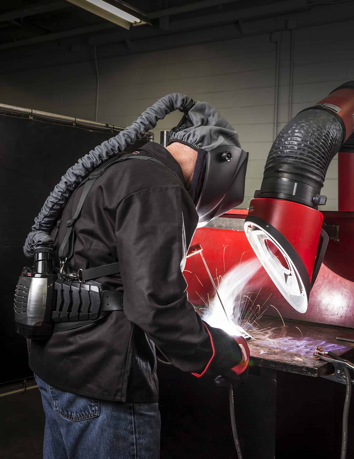 Stick welder using Viking PAPR (Powered Air Purifying Respirator) Helmet and Mobiflex 200-M welding fume extraction unit.